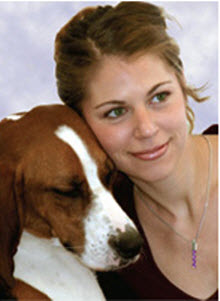 Dog snuggles with woman wearing Life Jewel